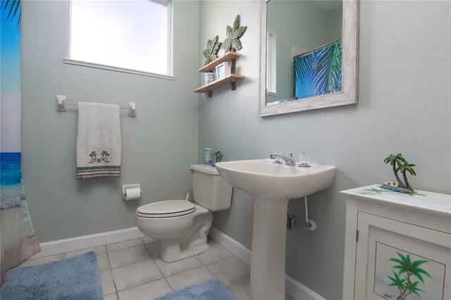 a bathroom with a sink toilet and a mirror