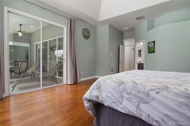 a bedroom with a bed and glass door