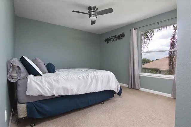 a bed sitting in a bedroom next to a window
