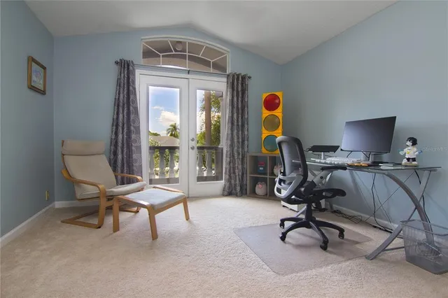 a view of a workspace with furniture and a window