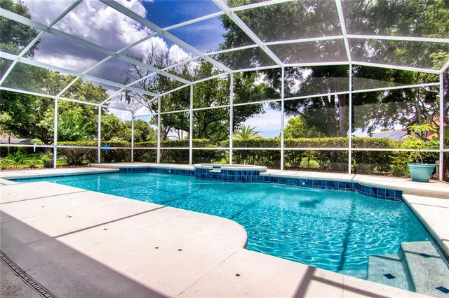 a view of an empty room with wooden floor and fence