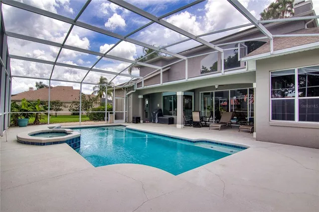 a view of a house with sitting area and a swimming pool