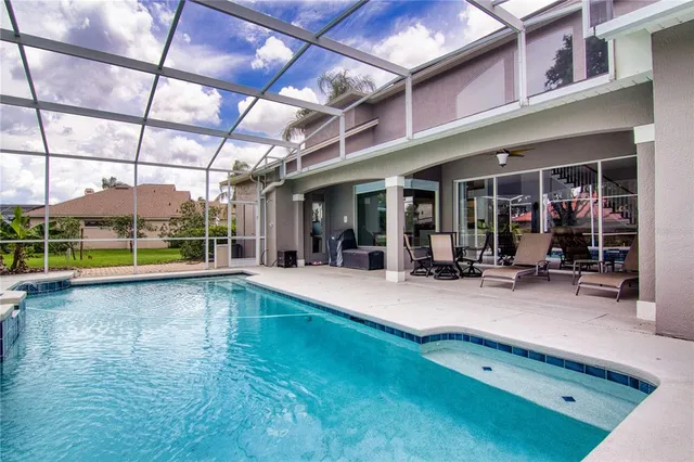 a view of a swimming pool with sitting area