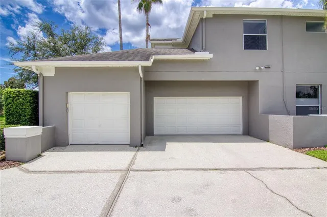 a front view of a house with garage