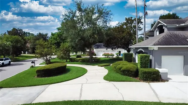 a view of a house with a garden and pathway