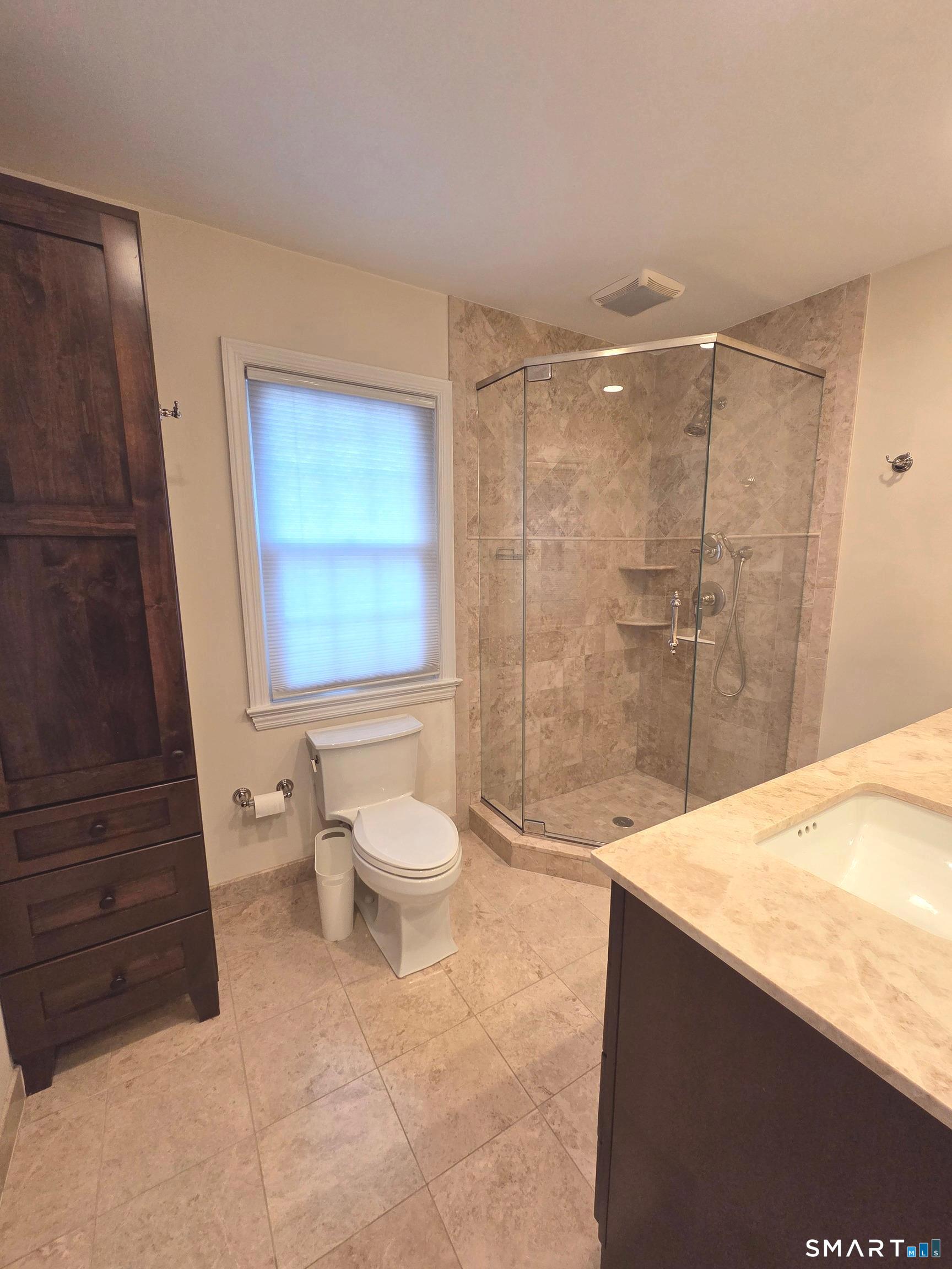 51 Glendale Road Stamford, CT 06905 - Photo 12 of 17 a bathroom with a sink a toilet and shower