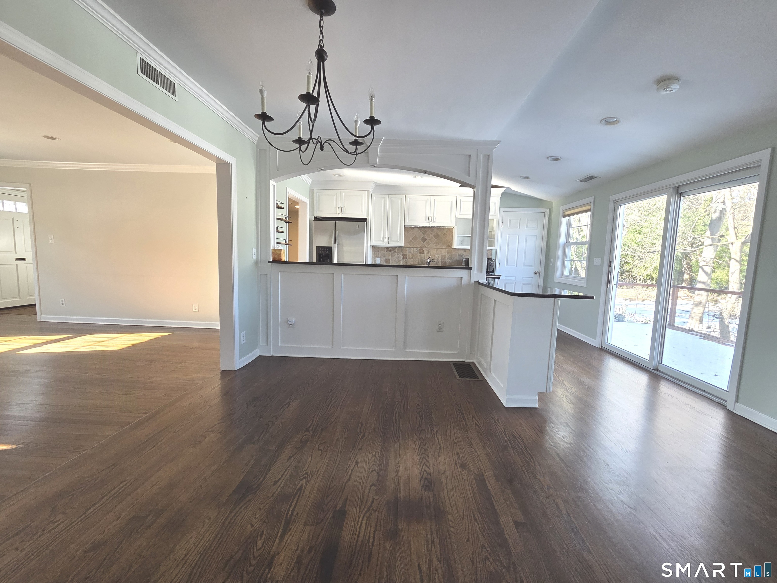 51 Glendale Road Stamford, CT 06905 - Photo 3 of 17 a kitchen with stainless steel appliances granite countertop wooden floors and white walls