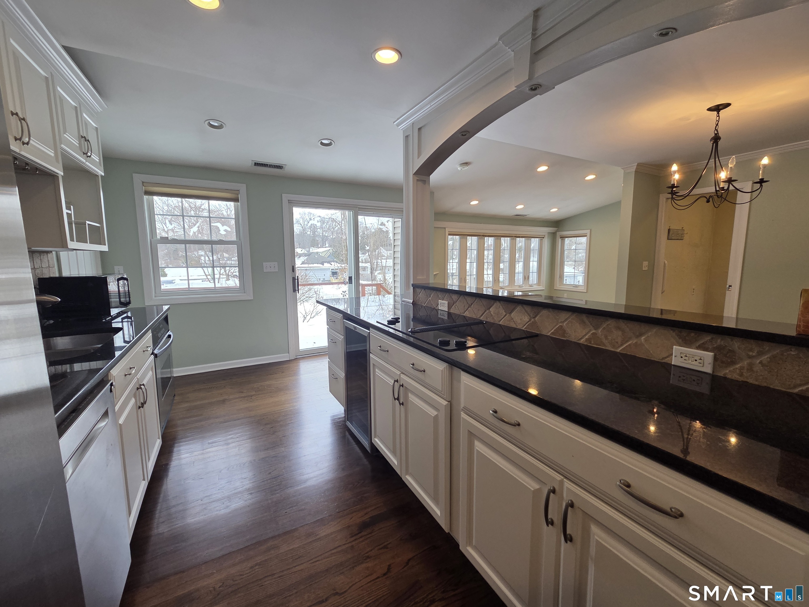 51 Glendale Road Stamford, CT 06905 - Photo 4 of 17 a large kitchen with granite countertop a stove and cabinets
