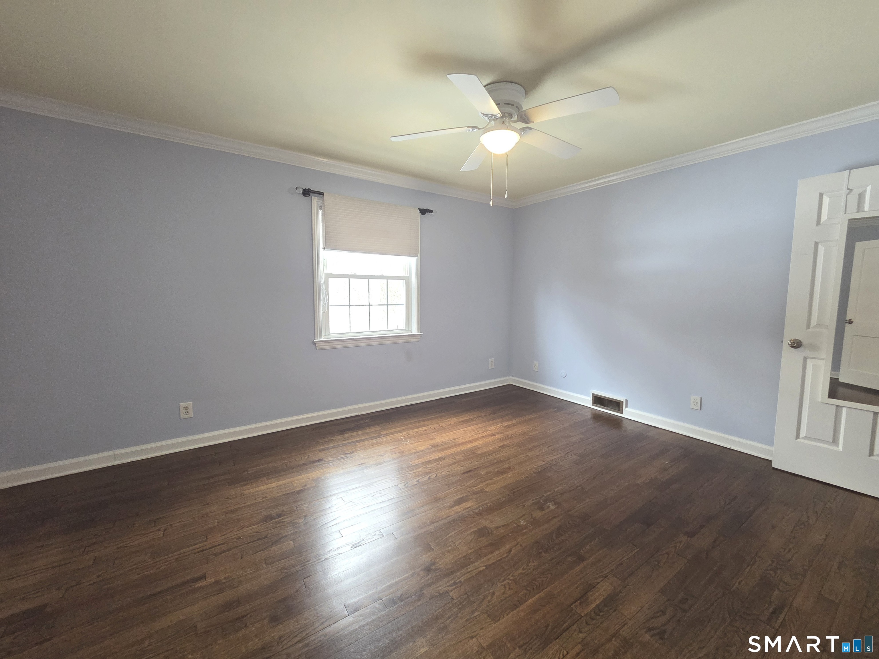 51 Glendale Road Stamford, CT 06905 - Photo 9 of 17 an empty room with wooden floor and windows