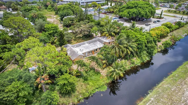 an aerial view of a house with a yard