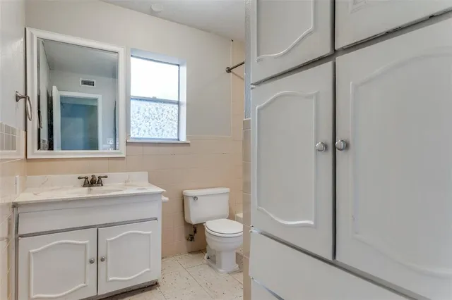 a bathroom with a sink tub vanity and a mirror