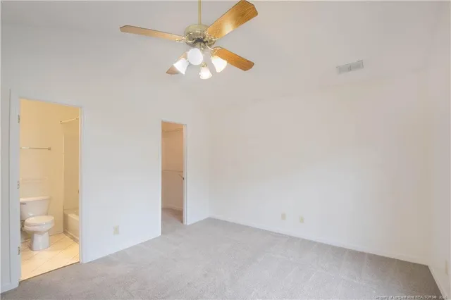 a view of an empty room with a fan