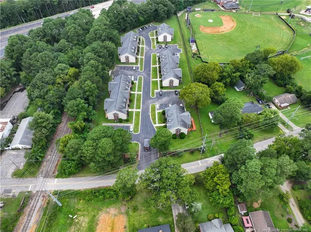 an aerial view of a house with outdoor space pool seating area and yard
