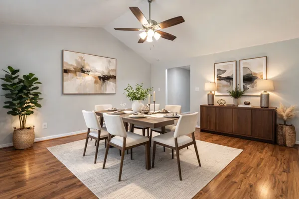 a view of a dining room with furniture and wooden floor
