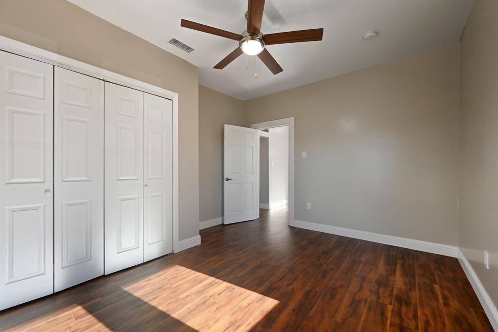4219 Frank Street Dallas, TX 75210 - Photo 12 of 23 a view of an empty room with window and wooden floor