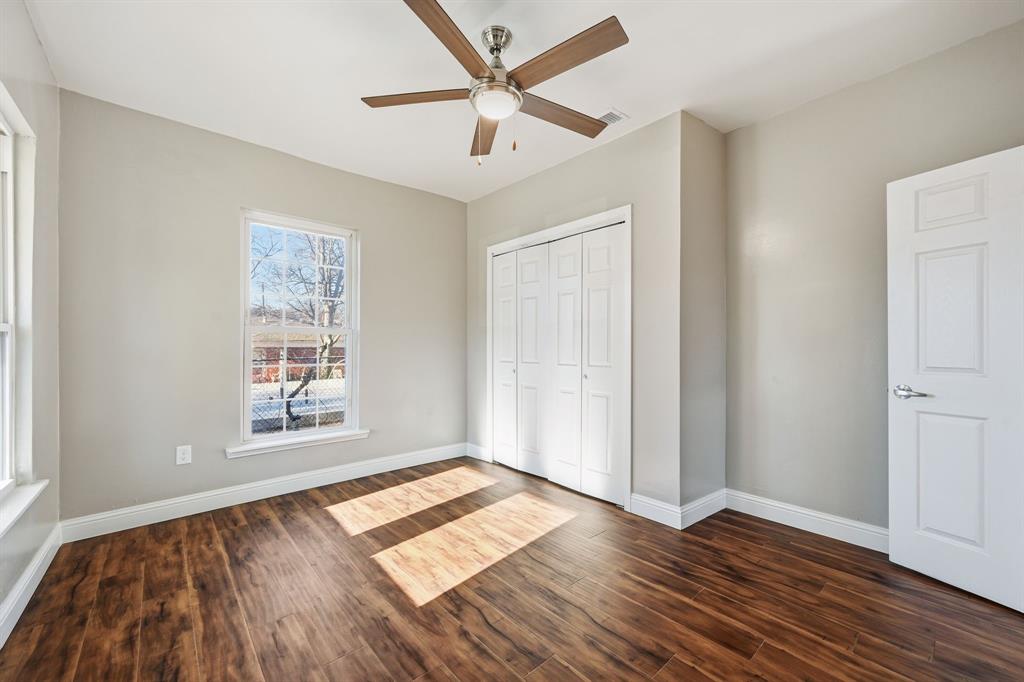 4219 Frank Street Dallas, TX 75210 - Photo 13 of 23 an empty room with wooden floor and windows