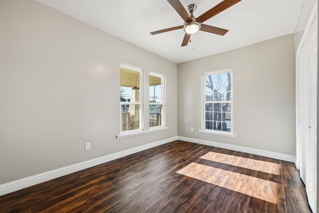 4219 Frank Street Dallas, TX 75210 - Photo 16 of 23 an empty room with wooden floor and windows