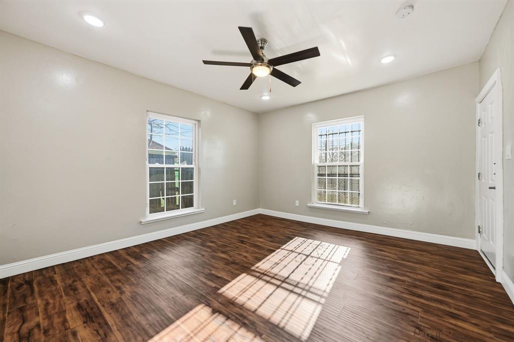 4219 Frank Street Dallas, TX 75210 - Photo 17 of 23 a view of an empty room with wooden floor and a window