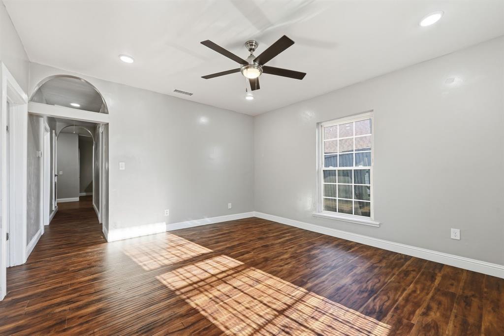 4219 Frank Street Dallas, TX 75210 - Photo 18 of 23 a view of a livingroom with a ceiling fan and wooden floor