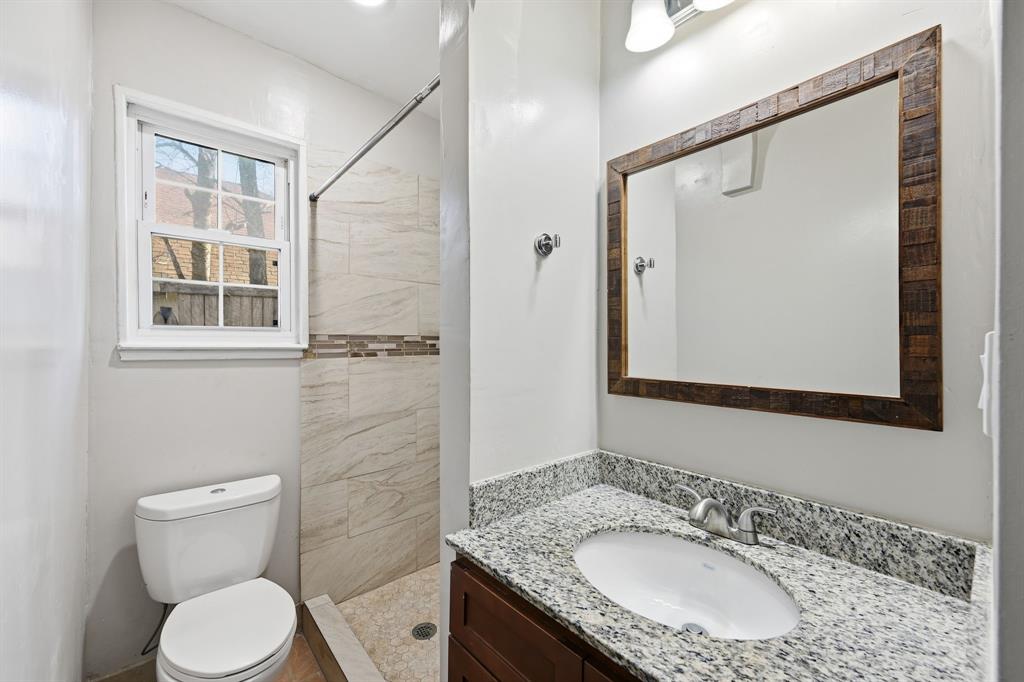 4219 Frank Street Dallas, TX 75210 - Photo 2 of 23 a bathroom with a granite countertop sink toilet and shower