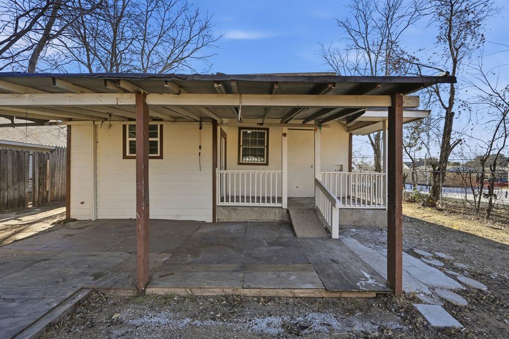 4219 Frank Street Dallas, TX 75210 - Photo 21 of 23 a view of a wooden house with a large window and potted plants