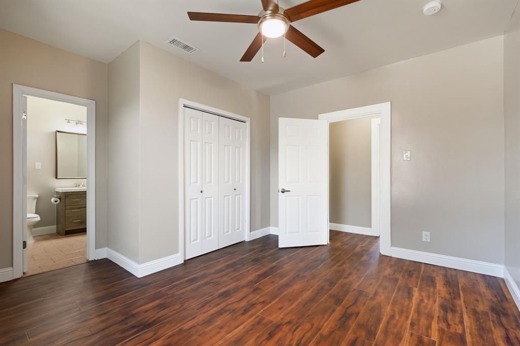 4219 Frank Street Dallas, TX 75210 - Photo 6 of 23 an empty room with wooden floor and windows