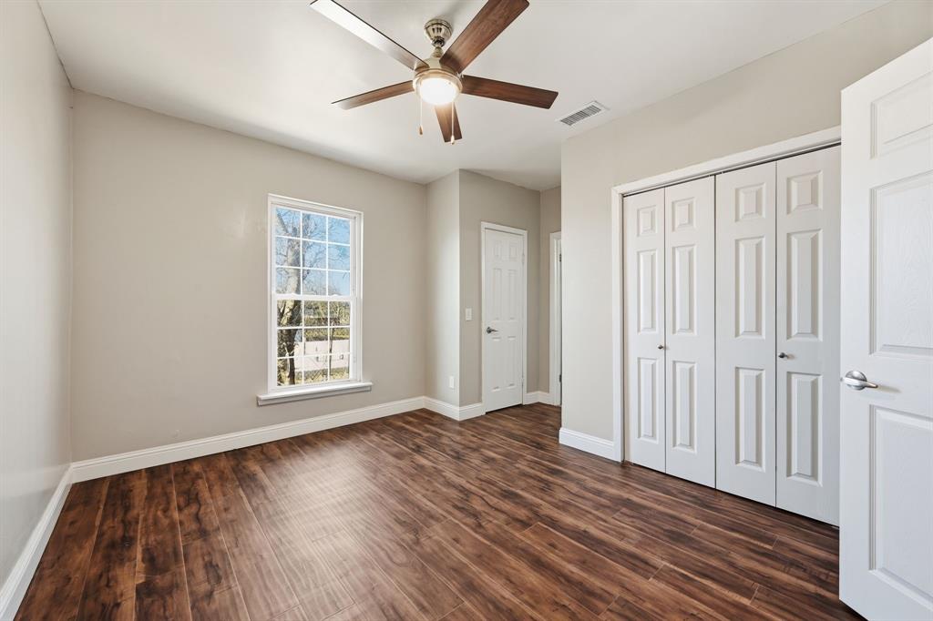 4219 Frank Street Dallas, TX 75210 - Photo 7 of 23 wooden floor in an empty room with a window