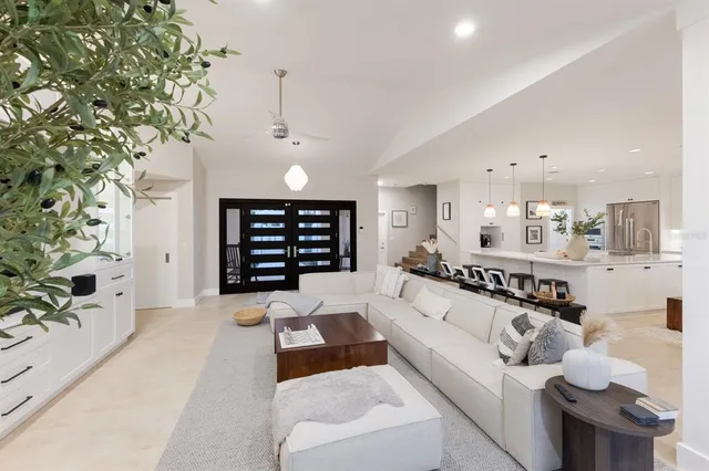 a living room with furniture and a floor to ceiling window