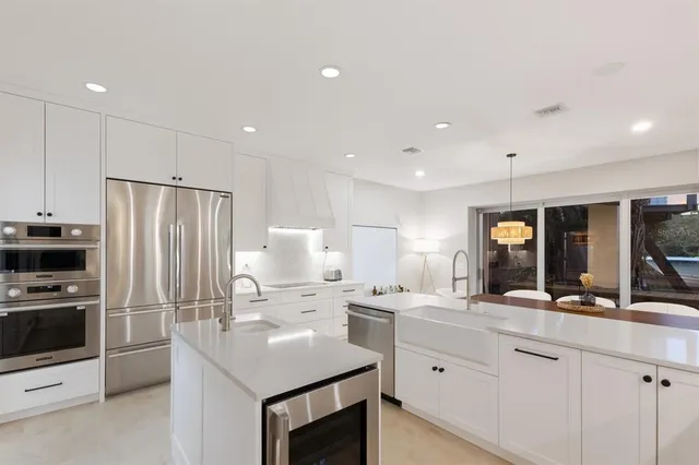 a kitchen with cabinets and stainless steel appliances