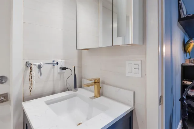 a bathroom with a sink a toilet and mirror