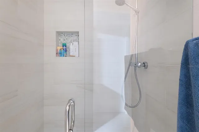 a bathroom with a glass shower door