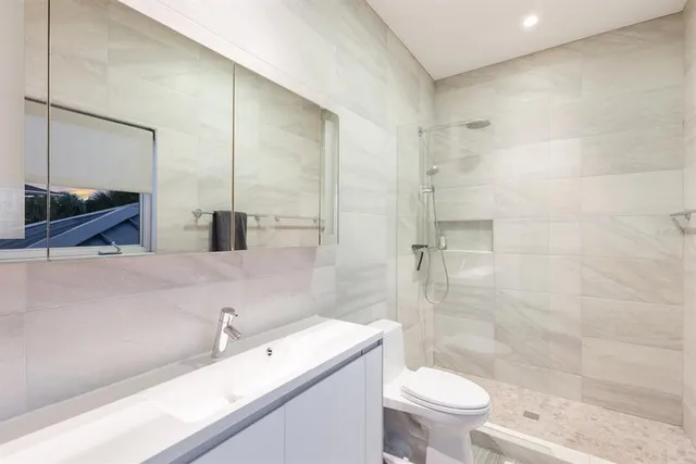 a living room with furniture a flat screen tv and a floor to ceiling window