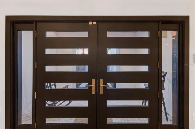 a living room with furniture kitchen view and a large window