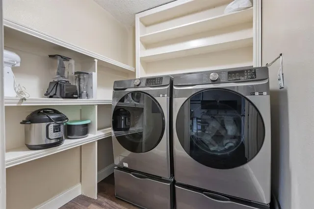 a utility room with sink dryer and washer