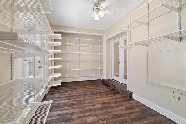a view of an empty room with wooden floor and entryway