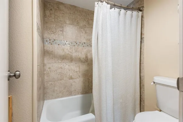 a bathroom with a shower and a toilet