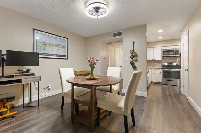 a view of a dining room with furniture and wooden floor