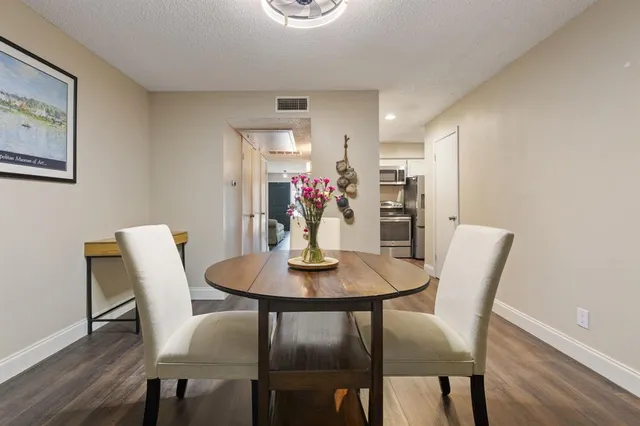 a view of a dining room with furniture and wooden floor