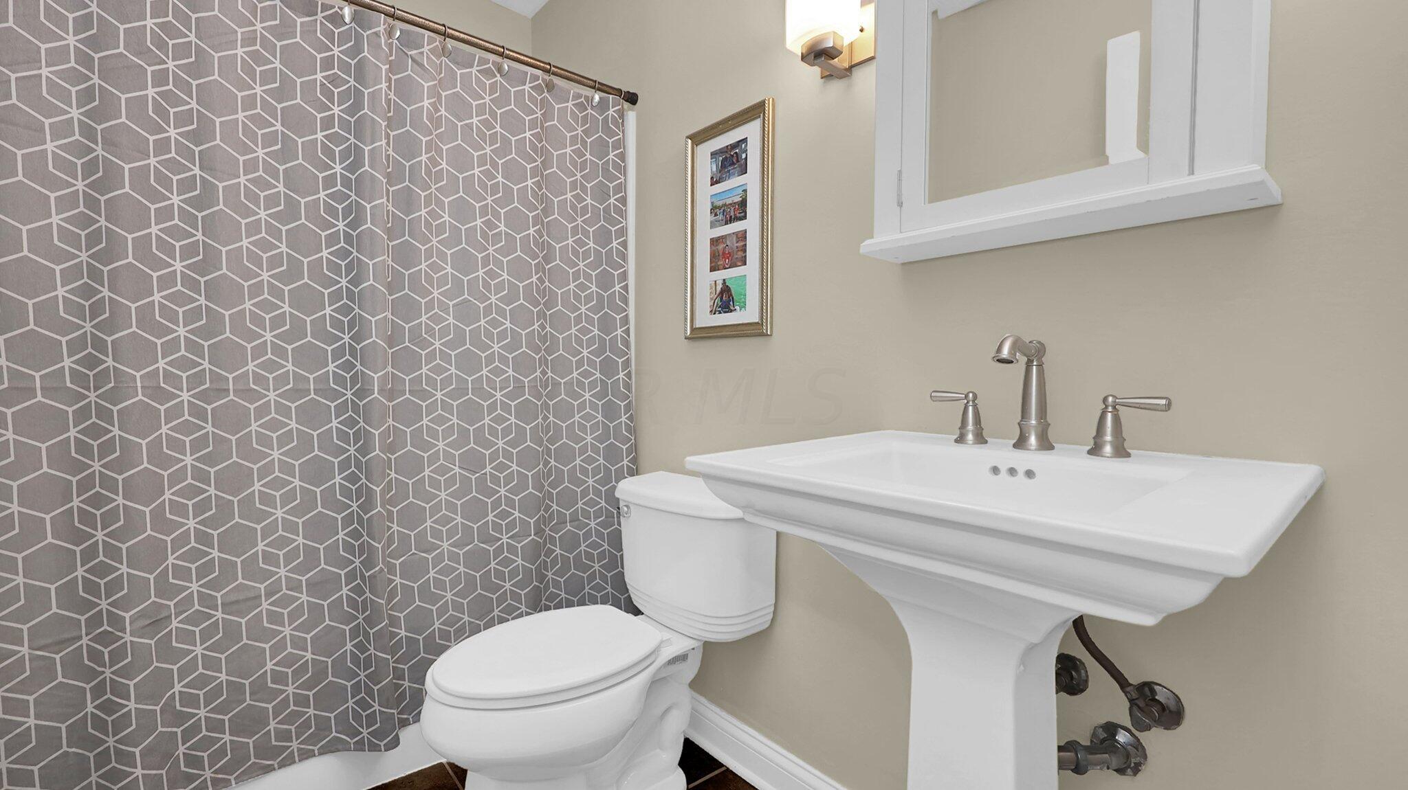 7790 Schott Road Westerville, OH 43081 - Photo 17 of 50 First floor FULL bathroom with pedestal sink and tub/shower combination!