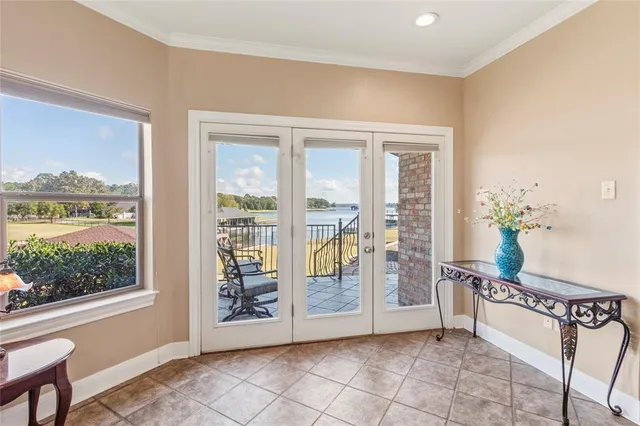 a bedroom with a large bed and a chandelier