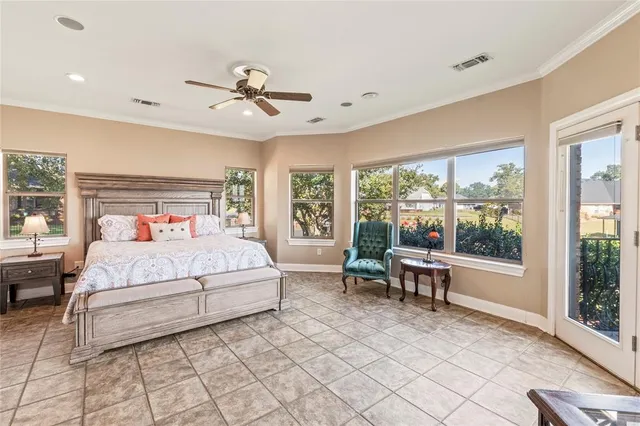 a bedroom with a large bed and a window