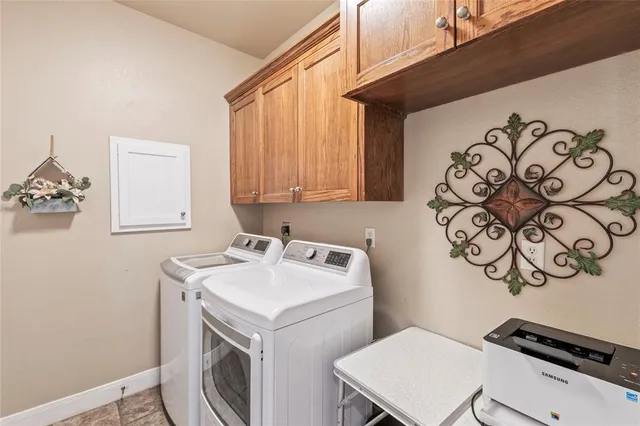 an aerial view of ocean and residential houses with outdoor space