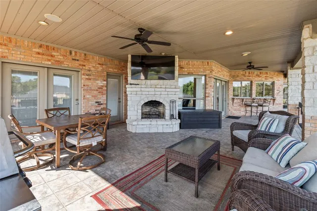 a living room with furniture a flat screen tv and floor to ceiling window