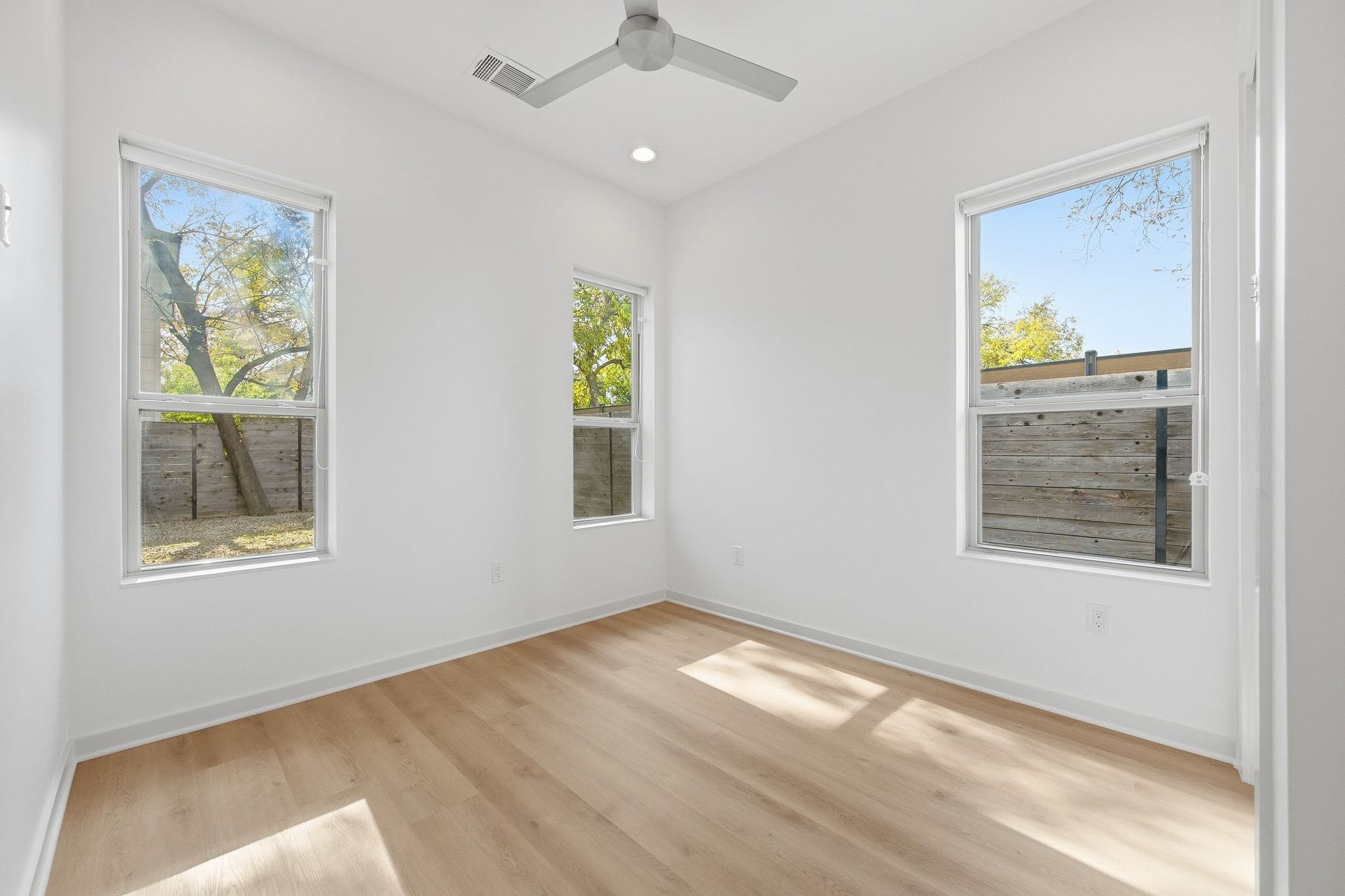 2811 Garwood Street, Unit B Austin, TX 78702 - Photo 14 of 24 Empty room with light wood finished floors, plenty of natural light, recessed lighting, and a ceiling fan