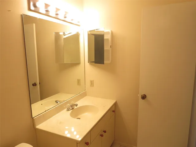 a bathroom with a sink and mirror