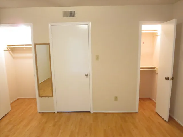 a view of room with wooden floor