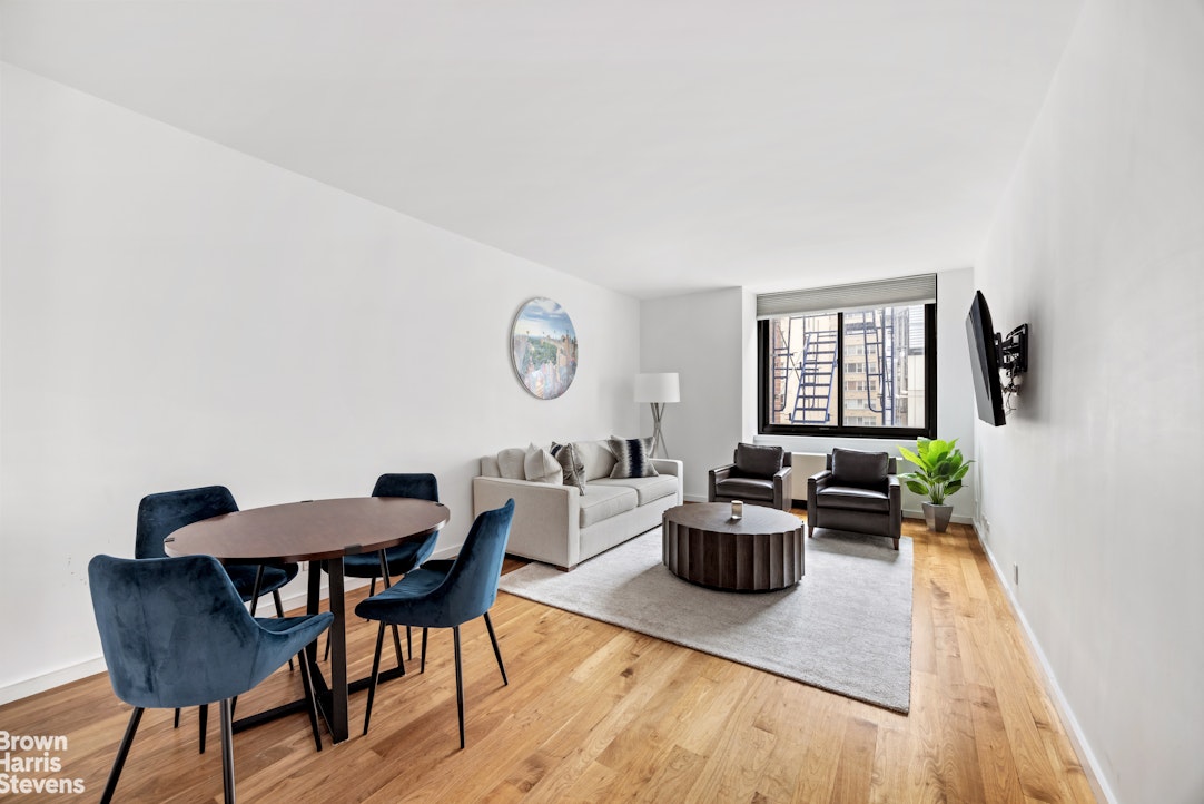 515 East 72nd Street, Unit 5F Manhattan, NY 10021 - Photo 2 of 16 a living room with furniture and a wooden floor