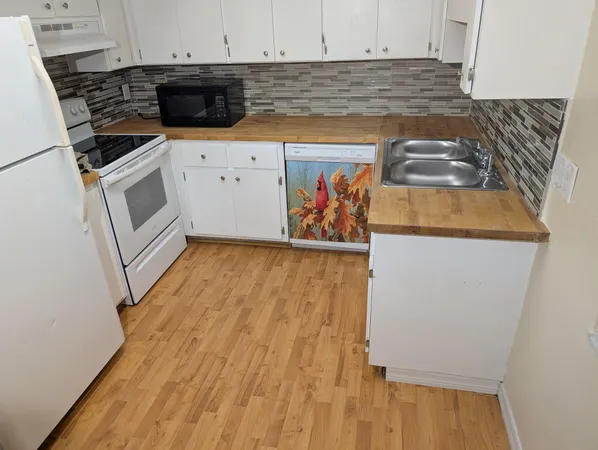 a kitchen with wooden cabinets and a stove