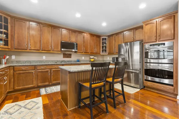 a kitchen with a stove a sink and a microwave