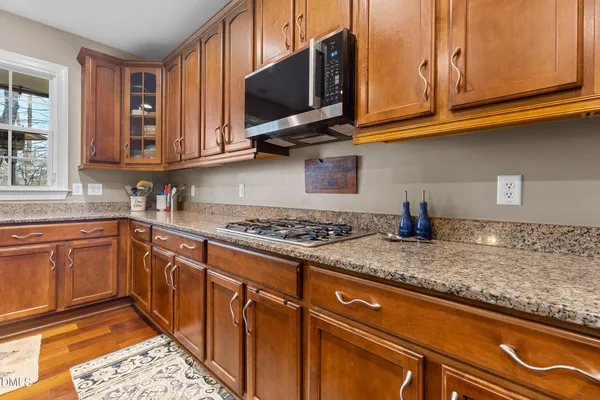 a kitchen with granite countertop a sink and cabinets